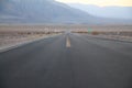 The never ending road during the dusk of a sunset in the Death Valley desert