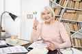 Cheerful mature woman studying hard Royalty Free Stock Photo