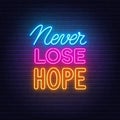 Never Lose Hope neon quote on brick wall background.