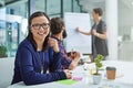 Never lose sight of your ambitions. Portrait of a young businesswoman sitting in a meeting with colleagues in the Royalty Free Stock Photo