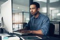 Never mind good, I demand great. a man using a computer in a modern office.