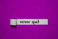 Never quit, Inspiration, Motivation and business concept on purple torn paper