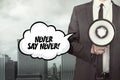 Never say never text on speech bubble with businessman Royalty Free Stock Photo