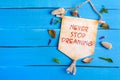 Never stop dreaming text on Paper Scroll Royalty Free Stock Photo