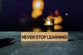 Never Stop Learning! on the sticky notes with bokeh background