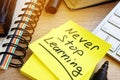 Never stop learning written on a stick. Lifelong learning concept. Royalty Free Stock Photo