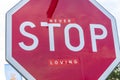 Never stop loving, abstract artwork in a stop road sign Royalty Free Stock Photo