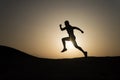 Never stop. Silhouette man motion running in front of sunset sky background. Future success depends on your efforts now Royalty Free Stock Photo