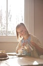 Never underestimate the power of a good cup of tea. A beautiful young woman pouring herself a cup of tea while sitting Royalty Free Stock Photo