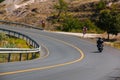 A motorcycle rider going on a curving road