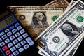 American aged and new  banknotes with calculator. USA dollars on the table Royalty Free Stock Photo
