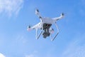 The New Aircraft DJI Phantom 4 pro quadcopter drone with 4K video camera and wireless remote controller flying in the sky. Aerial Royalty Free Stock Photo