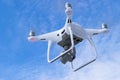 The New Aircraft DJI Phantom 4 pro quadcopter drone with 4K video camera and wireless remote controller flying in the sky. Aerial Royalty Free Stock Photo