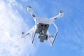 The New Aircraft DJI Phantom 4 pro quadcopter drone with 4K video camera and wireless remote controller flying in the sky. Aerial Royalty Free Stock Photo