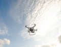 The New Aircraft DJI Phantom 4 pro quadcopter drone with 4K video camera and wireless remote controller flying in the sky. Aerial Royalty Free Stock Photo