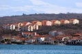 New apartment buildings above old Mediterranean town next to sea