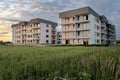 New apartment buildings with balconies on sunset sky background. Royalty Free Stock Photo