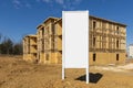 New Apartment Construction Framework With Blank White Sign In Foreground Royalty Free Stock Photo