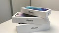 New Apple iPhone 14 Pro, 12 Mini and XR in boxes on white desk