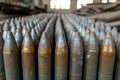 New artillery shells stored in warehouse of weapons factory, metal munition in military storage close-up. Concept of war,