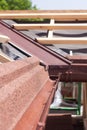 New asphalt shingle roof with brown rain gutter, wooden beams and vapour control layer. Royalty Free Stock Photo