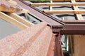 New asphalt shingle roof with brown rain gutter, wooden beams and vapour control layer. Royalty Free Stock Photo