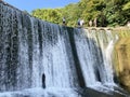 New Athos, Abkhazia, August, 09. 2019. People walking near artificial waterfall on the river Psyrtskha in the summer, the city of