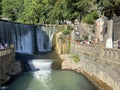 New Athos, Abkhazia, August, 09. 2019. People walking near artificial waterfall on the river Psyrtskha in the summer, the city of