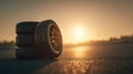 New automobile tires arranged on a road surface in golden sunset lighting, emphasizing durability Royalty Free Stock Photo