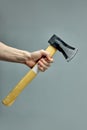 New Axe  On Gray Background In cropped male hands Royalty Free Stock Photo