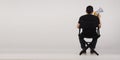 New.Back of Asian man sitting on black director chair. He holding a megaphone on white background