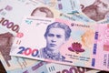 New banknote of 200 hryvnia against the background of 1000 hryvnia banknotes. Financial concept.