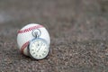New baseball with an old sport stopwatch Royalty Free Stock Photo