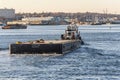 Tug Bucky towing barge into New Bedford in late afternoon
