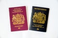 A new black British non European passport with an old red type passport Royalty Free Stock Photo