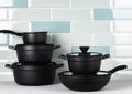 New black cookware against blue tile wall Royalty Free Stock Photo
