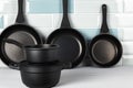 New black cookware against blue tile wall Royalty Free Stock Photo
