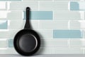 New black cookware against blue tile wall Royalty Free Stock Photo