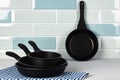 New black cookware against blue tile wall Royalty Free Stock Photo