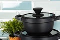 New black cookware against blue tile wall Royalty Free Stock Photo