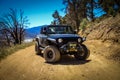 New black Jeep Wrangler JLU Sport on the sandy pathway in Big Bear, the United States