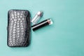 New black leather purse with lipstick and perfume Royalty Free Stock Photo