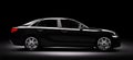 New black metallic sedan car in spotlight. Modern desing, brandless. Royalty Free Stock Photo