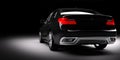 New black metallic sedan car in spotlight. Modern desing, brandless. Royalty Free Stock Photo