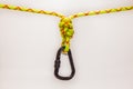 New Black oval touristic and alpinistic carabine hangs from double figure eight 8 knot. Stretched colored, green rope