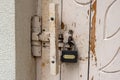 New black padlock on old white rusty door Royalty Free Stock Photo