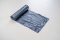 new black trash bag roll on the colorful surface, isolated, care the planet Royalty Free Stock Photo