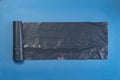 new black trash bag roll on the colorful surface, isolated, care the planet Royalty Free Stock Photo