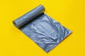 new black trash bag roll on the colorful surface, isolated, care the planet Royalty Free Stock Photo