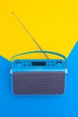 New blue digital DAB+ radio stylized on vintage lay on blue and yellow background